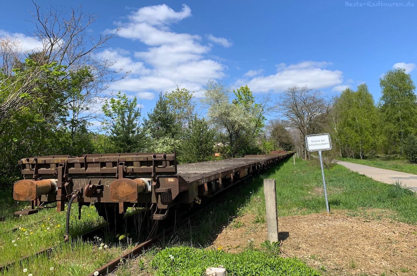 Foto vom Storchen-Radweg aus: Alter Transport-Zug auf ehemaliger Bahntrasse bei Brielower Ausbau